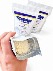 Open Zoapster Bath Sherbet pouch showing the powder texture, with two pouches behind.