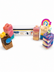 Group of colourful handmade Zoapster soap bars arranged with the display sleeve.