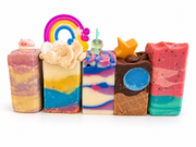 Five handmade Zoapster soap bars in different colours and designs.