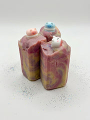 Handmade bedtime honey soap bars with soft pink swirls on a white background
