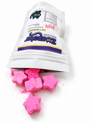 Zoapster Pink Bath Sprinkles pouch beside pink star-shaped sprinkles.