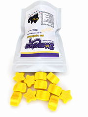 Zoapster Yellow Bath Sprinkles pouch beside yellow star-shaped sprinkles.