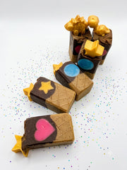 A group of chocolate cone soap bars with gold star toppers