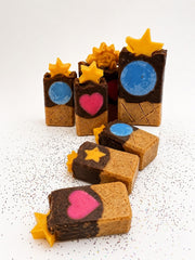 A scattered group of handmade chocolate cone soap bars with star toppers and embedded hearts