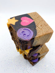 chocolate cone soap bars stacked, one with a smiley face topper