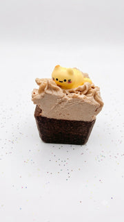 A single salty chocolate whipped soap bar with a piped cream top and a cat topper