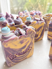 A batch of honey and lavender swirled soap bars with pastel piped tops